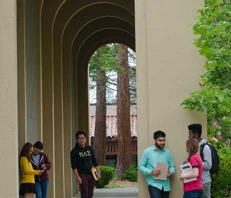 Students relax under tall arches