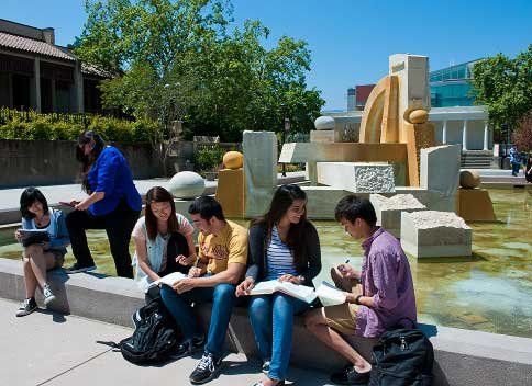 students study at a beautiful fountain