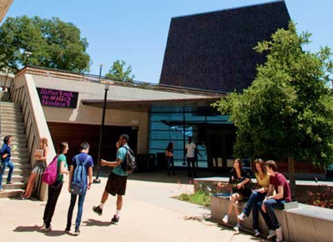 students study and talk near fountain
