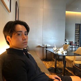 young man sitting in restaurant